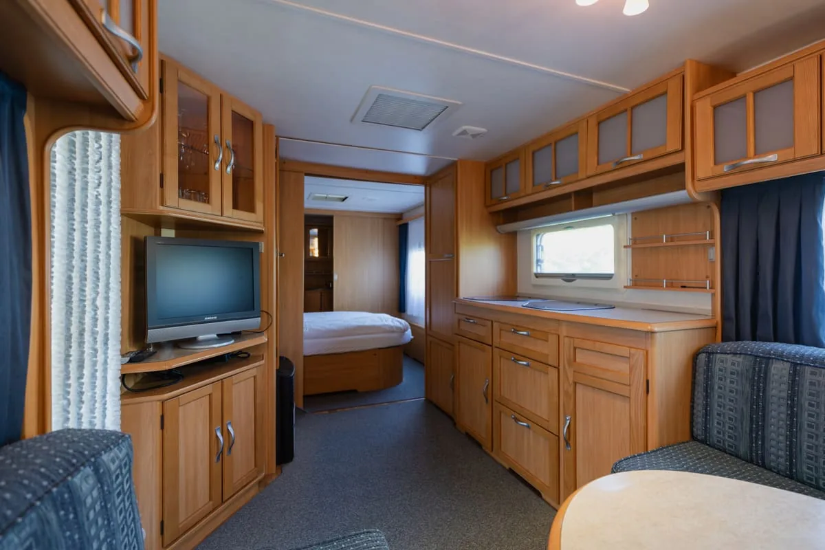 Rental caravan interior with seating and kitchen